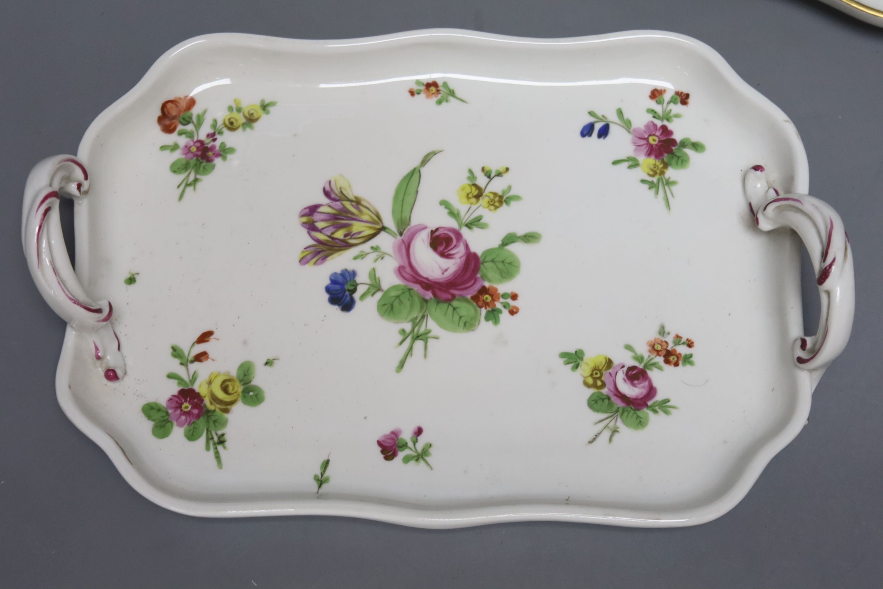 Two 18th century Vienna porcelain trays and a seated figure, largest tray 16cm